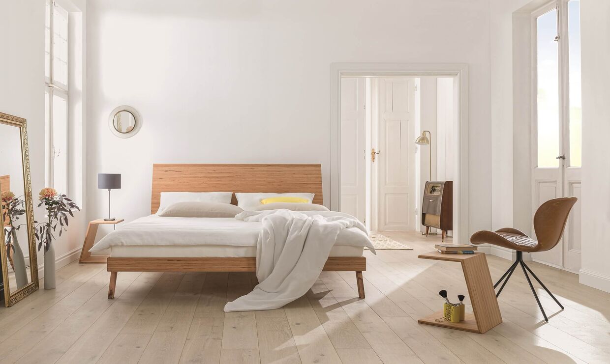 Dormiente-Bett aus mittelhellem Holz in einem hellen Raum mit hellem Holzboden und passendem Interior