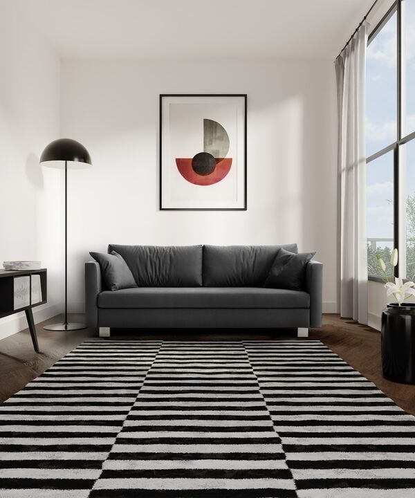 Graues Zweisitzersofa von Signet in der Frontalansicht auf einem schwarz-weiß gestreiften Teppich